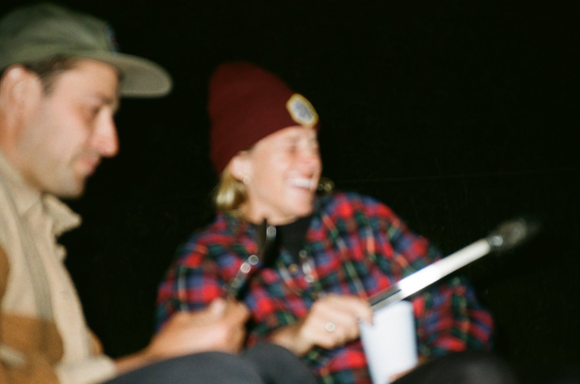 Film Photo of a girl at the campfire. cold camping. beach camping.